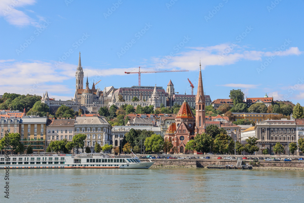 BUDAPEST, HUNGARY - OCTOBER 2022: Panoramic view of Budapest skyline, Buda castle and Danube river on a day with blue sky background.