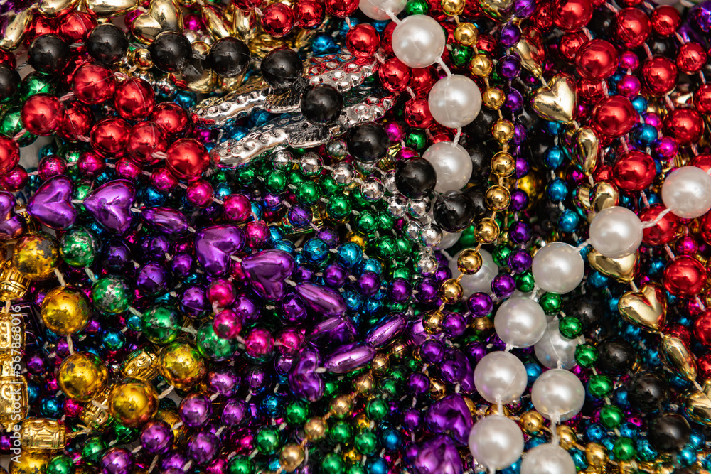 Many colorful mardi gras beads in a pile background Many colorful mardi gras beads in a pile background