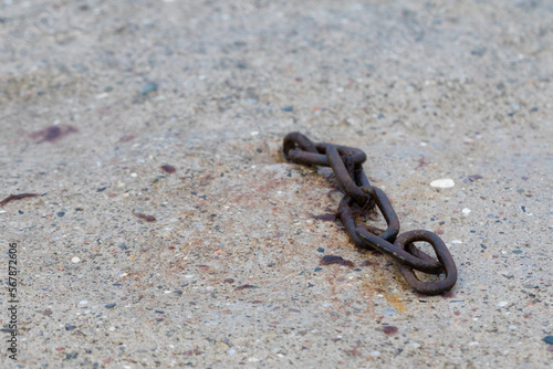 iron chain lying on a sandy beach