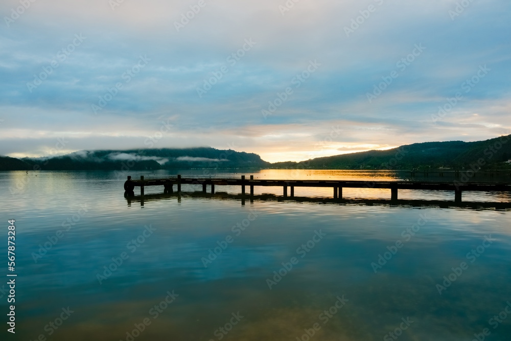 Pier on Lake Taupo on calm morning at sunrise
