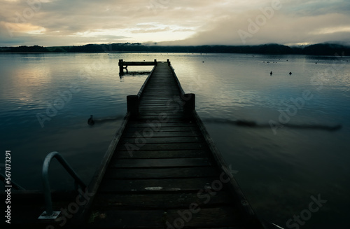 Pier on Lake Taupo on calm morning at sunrise