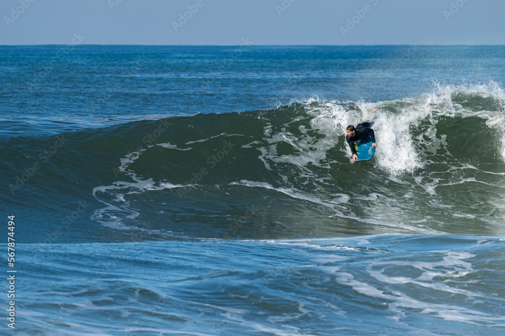 Bodyboarder surfing ocean wave