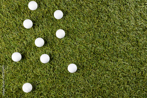 Close up of white golf balls on grass with copy space