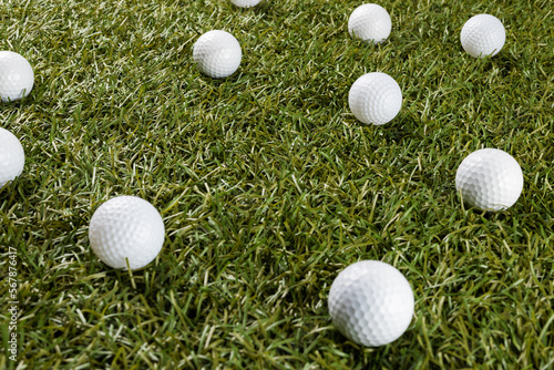 Close up of white golf balls on grass with copy space