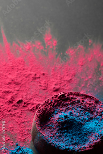 Close up of red and blue powder with round dish and copy space