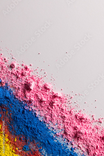 Close up of multi coloured powder with copy space on white background