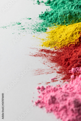Close up of multi coloured powder and copy space on white background