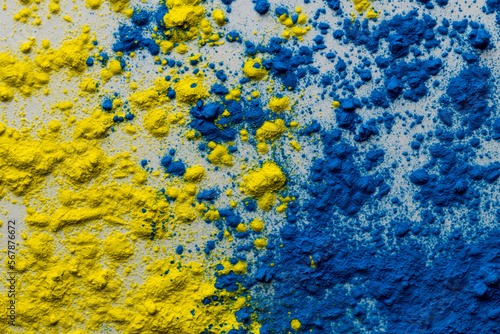 Close up of yellow and blue coloured powder with copy space