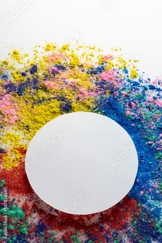 Close up of multi coloured powder with white circle and copy space