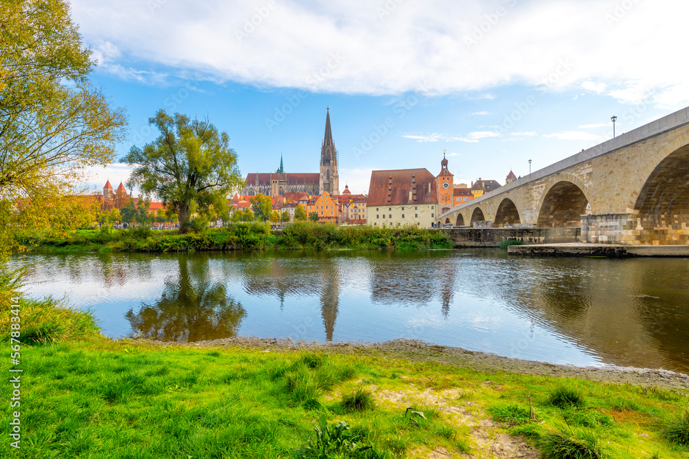 The old stone bridge over the Danube River with the Saint Peter Cathedral in view in the Bavarian city of Regensburg, Germany.	