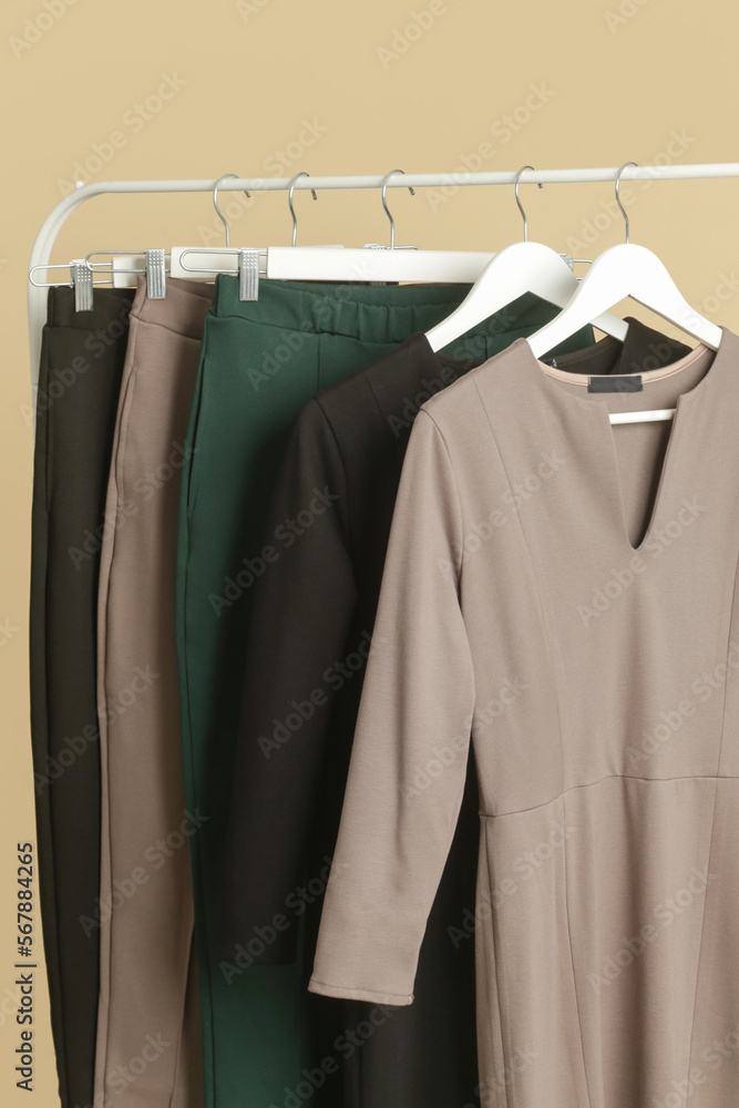 Women's Clothes. Clothes rack with stylish and elegant garments in fashion atelier. Good quality timeless fashion pieces. Women's Clothes. Clothes rack with stylish and elegant garments in fashion atelier. Good quality timeless fashion pieces.