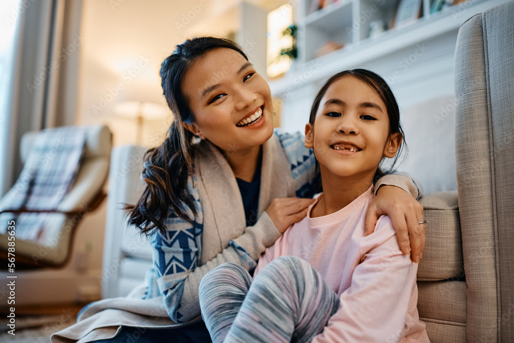 Portrait of happy Asian mother and daughter at home looking at camera. Portrait of happy Asian mother and daughter at home looking at camera.