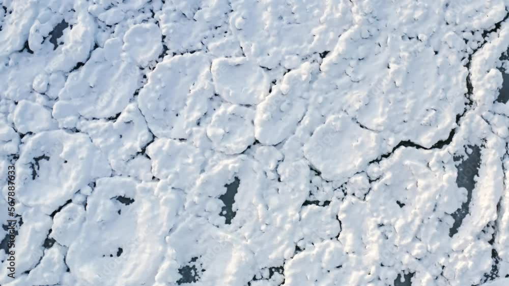 Lowering down aerial above scale-like Lake Michigan ice chunks encrusted in white snow from a polar vortex that moved through the Chicago region. Lowering down aerial above scale-like Lake Michigan ice chunks encrusted in white snow from a polar vortex that moved through the Chicago region.