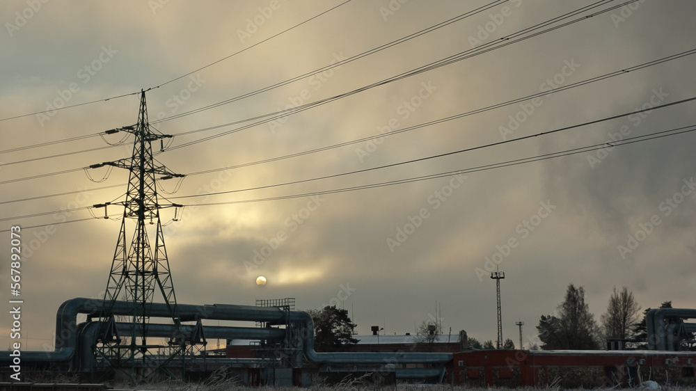pipeline and power lines against the gray sky