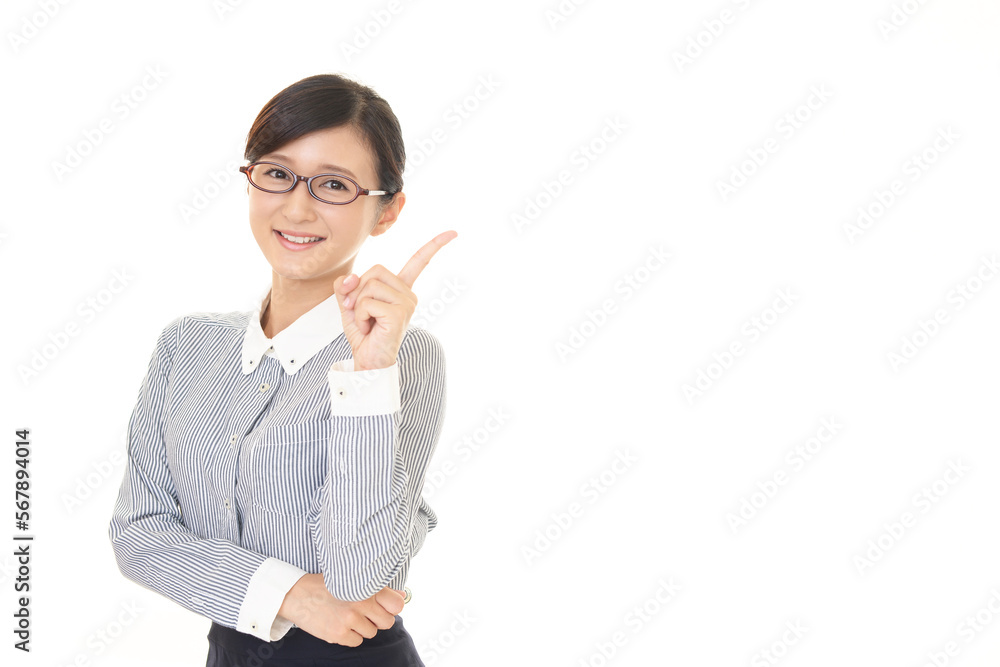 指さす笑顔のビジネスウーマン 指さす笑顔のビジネスウーマン