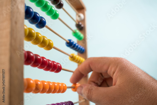 Colorful wooden abacus on green background