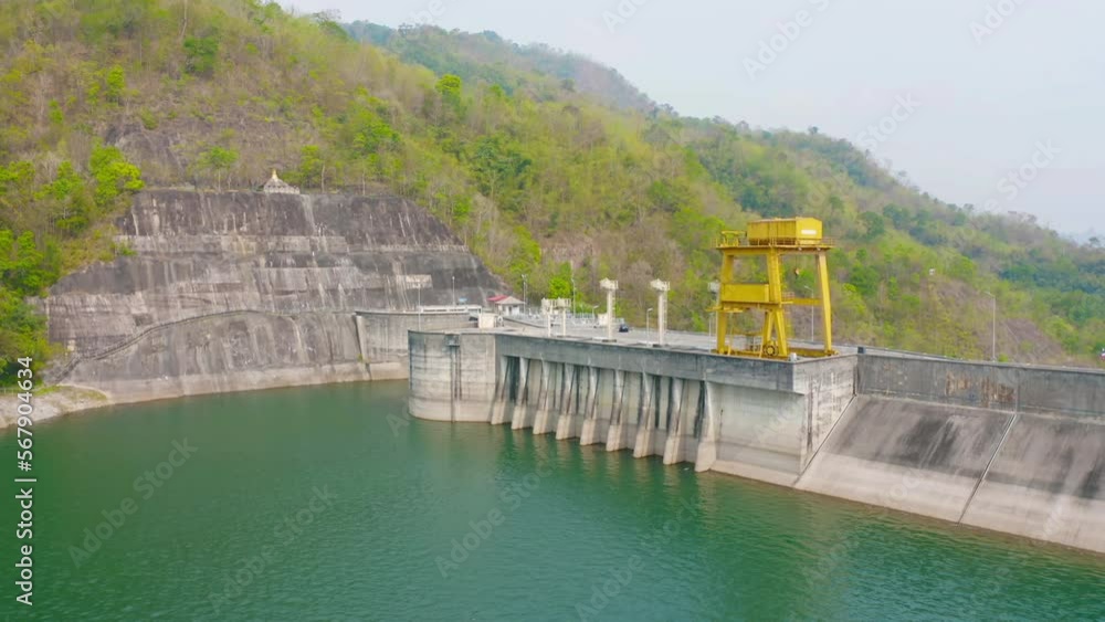 Aerial view of dam tower crane. Reservoir and sea water in recycle energy industry concept for electricity in Natural landscape background. Environment. Aerial view of dam tower crane. Reservoir and sea water in recycle energy industry concept for electricity in Natural landscape background. Environment.