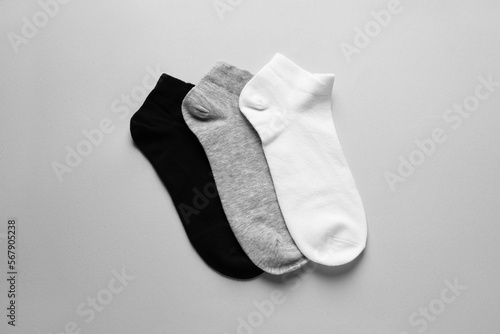 Different socks on light grey background, flat lay