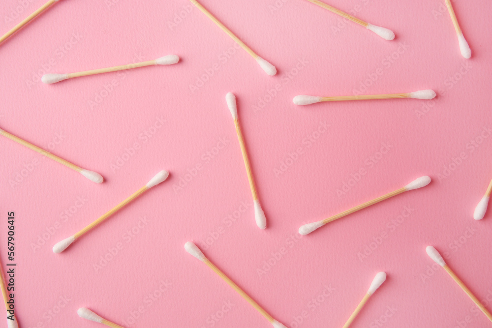 Many clean cotton buds on pink background, flat lay Many clean cotton buds on pink background, flat lay