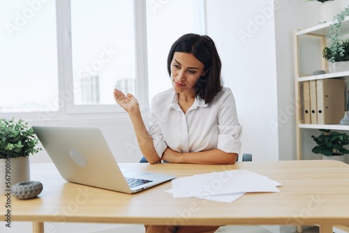 Woman business freelancer via video link via laptop shows papers online for startup, smile and happiness in employee chat, training online