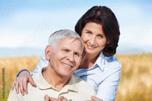 Mature old couple looking happy outdoors at farm,