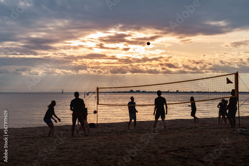 sunset on the beach playing volleyball