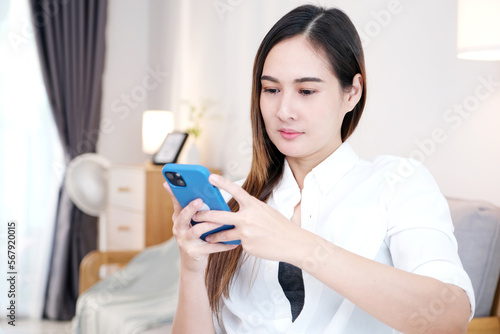 Young asian woman using phone with smiling, happy and relax emotion at home background, Happy asia girl on phone, people and technology, lifestyle