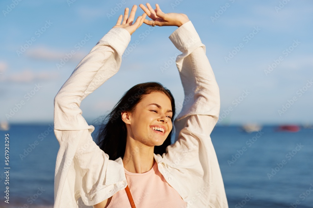 Woman smile with teeth freedom on vacation walking on the beach by the ocean in Bali sunset, happy travel and vacation, sunset light, flying hair Woman smile with teeth freedom on vacation walking on the beach by the ocean in Bali sunset, happy travel and vacation, sunset light, flying hair