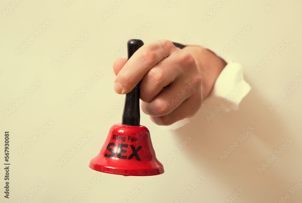 hand holding a bell. Sexy toy. Sexy gift. hand holding a bell. Sexy toy. Sexy gift.