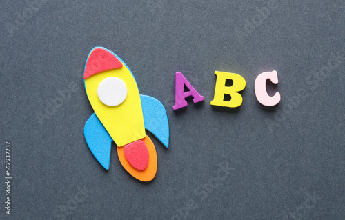 Space rocket and abc letters on gray background. Education concept