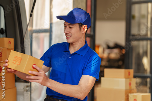 Delivery man asia people checking portable delivery device with parcel box to customer home address. © M+Isolation+Photo