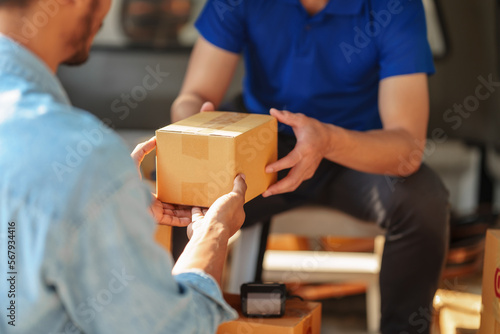 Delivery man asia people checking portable delivery device with parcel box to customer home address.