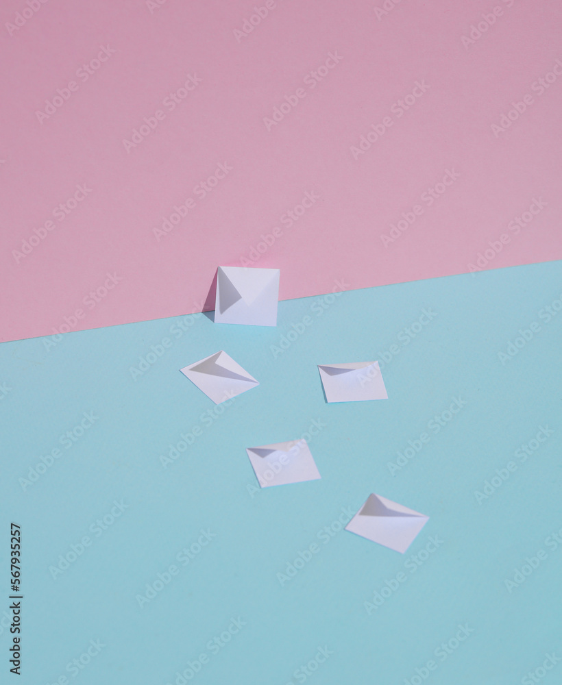 Paper-cut envelopes on blue-pink pastel background. Creative layout Paper-cut envelopes on blue-pink pastel background. Creative layout