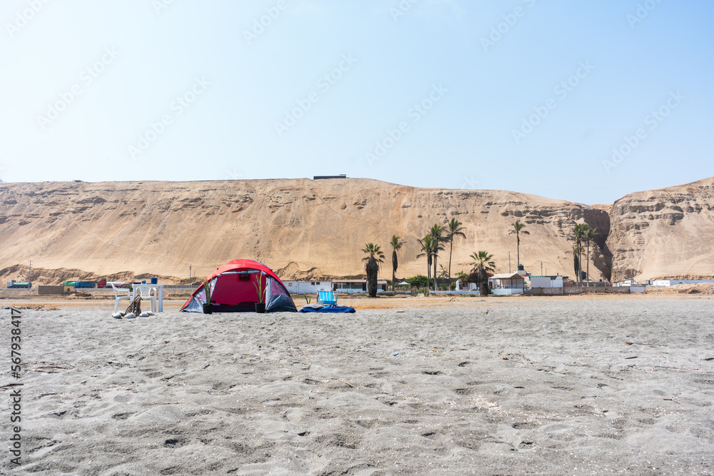 Background photos of a tent on the beach with a blue sky.