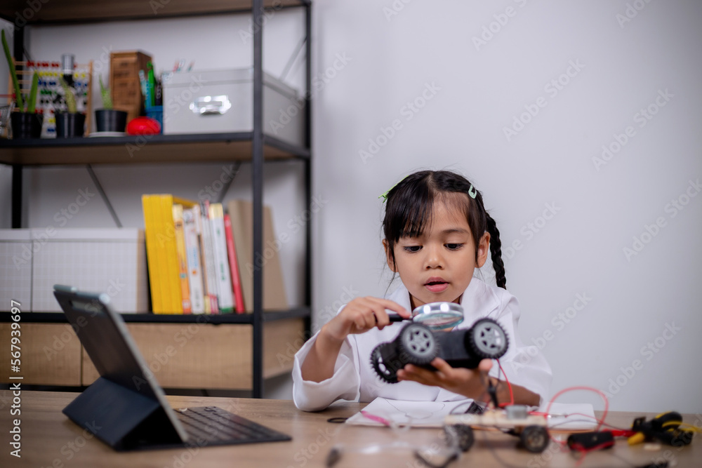 Asian students learn at home by coding robot cars and electronic board cables in STEM, STEAM, mathematics engineering science technology computer code in robotics for kids' concepts. Asian students learn at home by coding robot cars and electronic board cables in STEM, STEAM, mathematics engineering science technology computer code in robotics for kids' concepts.
