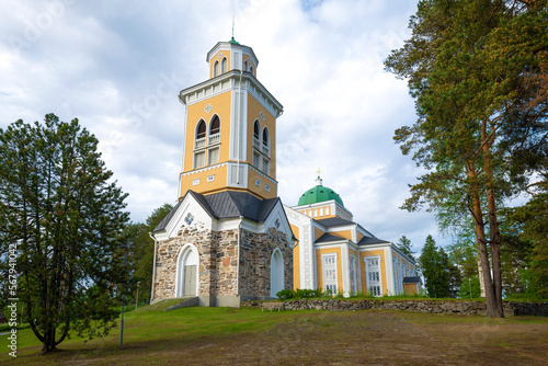 View of Finland's largest wooden church on a June cloudy morning. Kerimaki, Finland photo