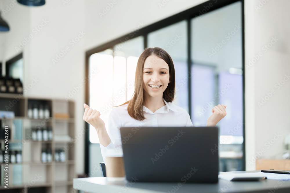 Excited businesswoman using computer laptop while in office, business concepts. Excited businesswoman using computer laptop while in office, business concepts.