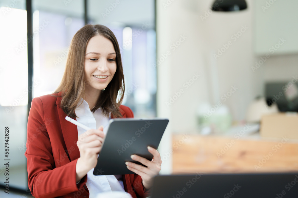 business owner or Asian female marketers are using tablet computer in office work business owner or Asian female marketers are using tablet computer in office work