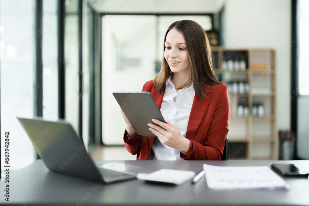 business owner or Asian female marketers are using tablet computer in office work business owner or Asian female marketers are using tablet computer in office work