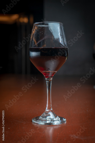 Wine glass on a bar table.