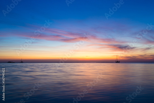 Colorful sunset over ocean on tropical island © Pakhnyushchyy