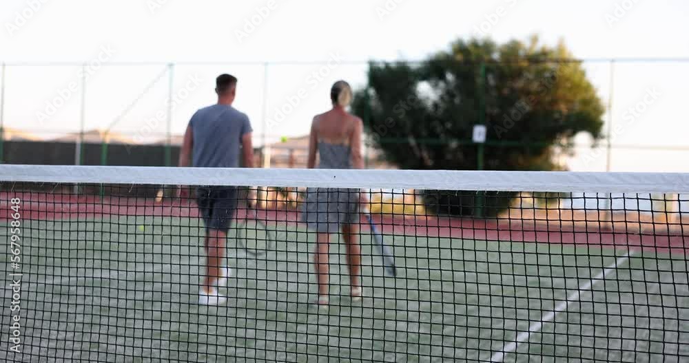 Tennis couple and on court for training together in great outdoors for good health Tennis couple and on court for training together in great outdoors for good health