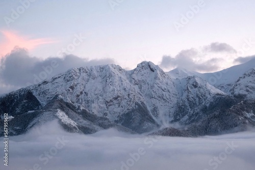 Winter scenery of panorama of Tatras Mountains with characteristic Giewont peak with cross, and clouds under them from Gubalowka hill in Zakopane, Podhale, Poland