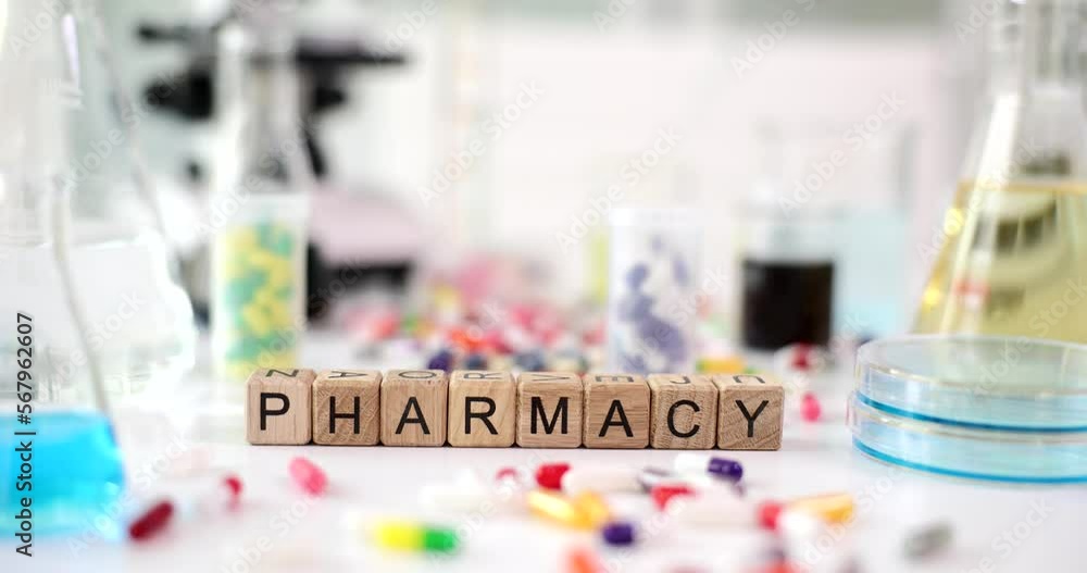Test tube and flasks with microscope and pills of different colors and medical pills in laboratory Test tube and flasks with microscope and pills of different colors and medical pills in laboratory