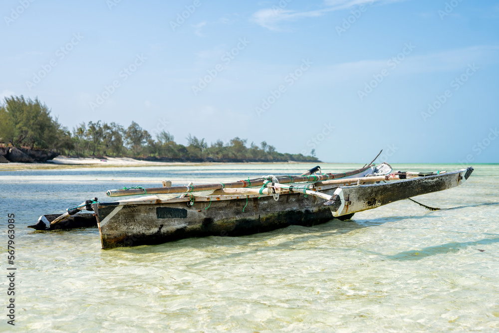 Traditional wooden fishing boat on the beach in Zanzibar