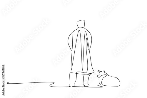 old mature man walking his dog outside relaxing back view