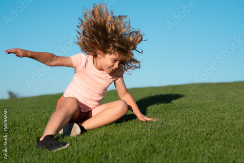 Fotografie Kid falling down on the grass