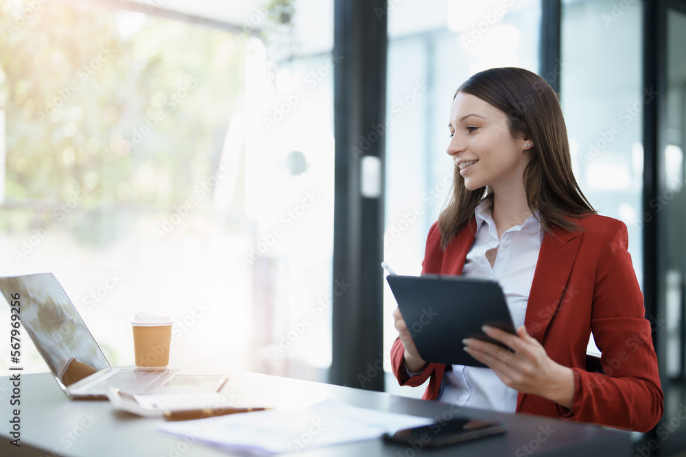 business owner or Asian female marketers are using tablet computer in office work business owner or Asian female marketers are using tablet computer in office work
