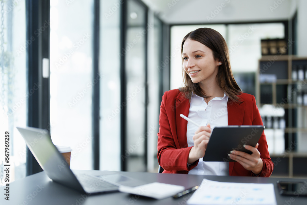 business owner or Asian female marketers are using tablet computer in office work business owner or Asian female marketers are using tablet computer in office work