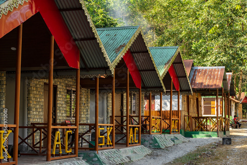 Few beautiful wooden cottages at famous Shivakhola Adventure Camp on the bank of river at Kurseong, West Bengal, India. photo